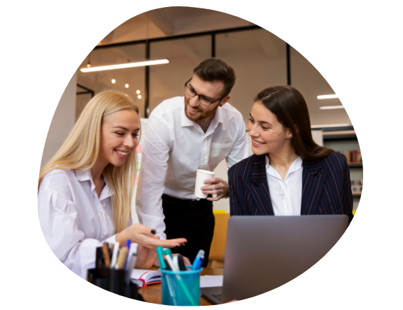 Team collaborating at office desk with laptop